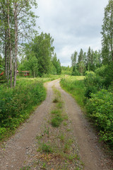 Dirt road in countryside in Finland at summer day