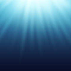 Light effect, sun rays, beams shining true the blue water.