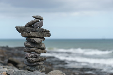 Close-up of stack of stones in perfect balance on a tranquil sunny beach in Fuerteventura, SpainClose-up of stack of stones in perfect balance on a tranquil sunny beach in Fuerteventura, Spain