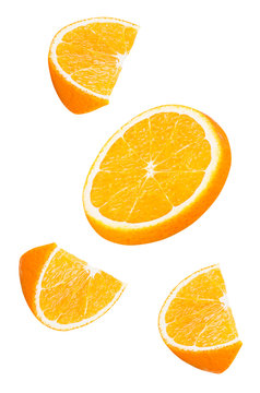 Isolated falling orange fruits pieces. Slices of orange in the air isolated on white background with clipping path