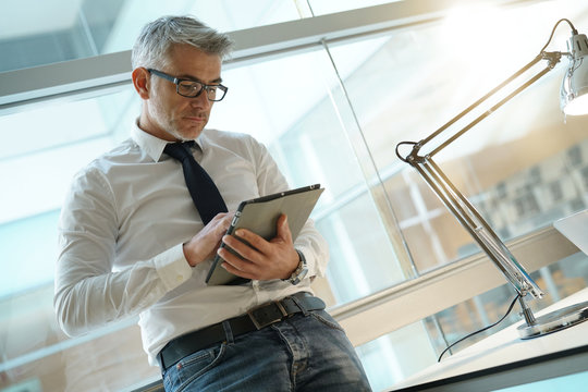 Businessman in office connected with digital tablet