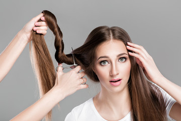Naklejka premium woman with long hair holds scissors 