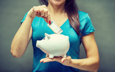 Piggy bank savings woman smiling happy