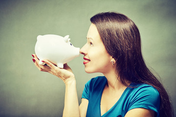 Piggy bank savings woman smiling happy