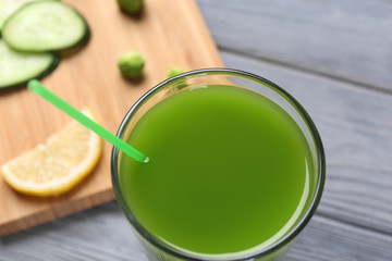 Glass with fresh vegetable juice on table, closeup