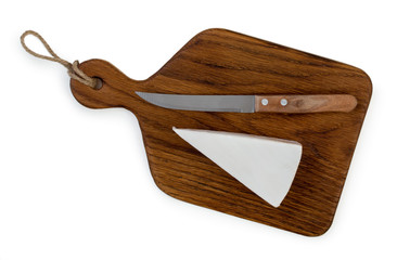 Slice of cheese brie and knife on oak wood cutting board with rope, isolated on a white background, top view.