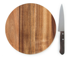 Chef knife near a round cutting board made from acacia wood isolated on white background, top view