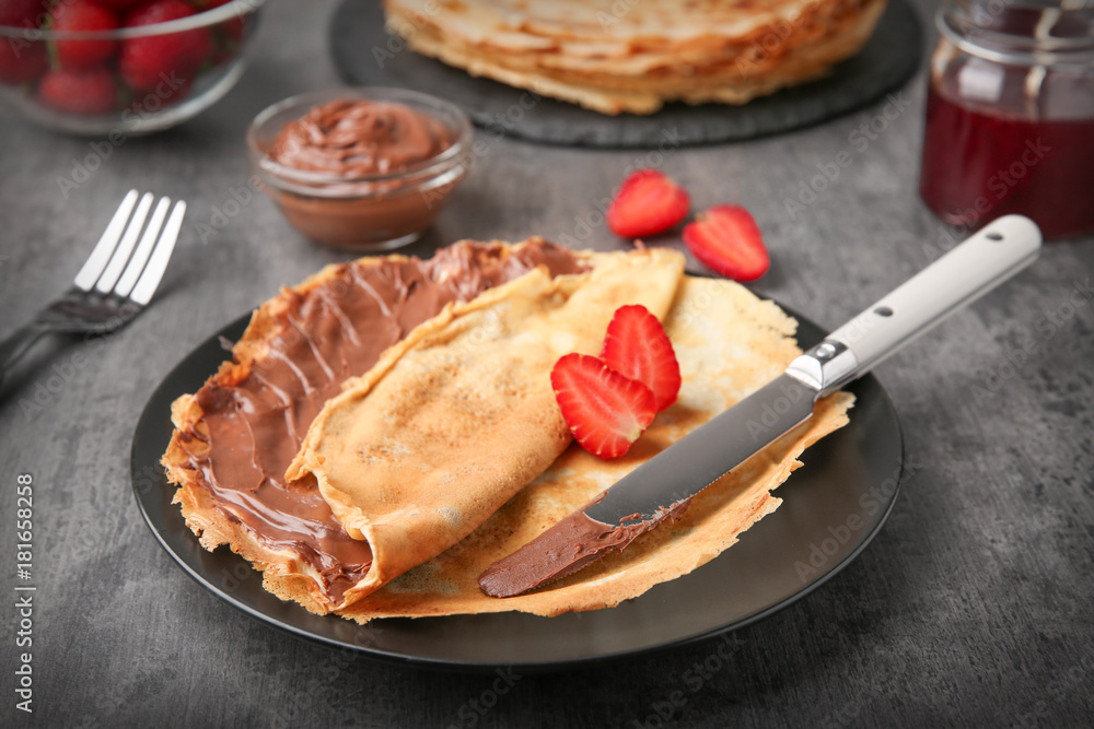 Canvas Prints plate with thin pancakes with chocolate paste and berries on table