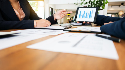 financial business. Two young executives partner discussing with macro economic and stock market investment