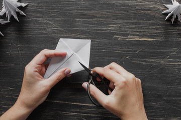 Hands making origami Christmas tree