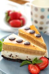 Pieces of layered mousse cake with caramel on plate