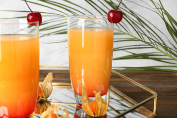 Glasses with tasty exotic cocktail on tray