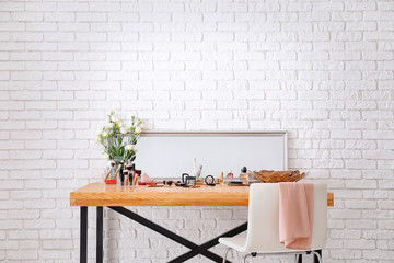 Set of decorative cosmetics and beauty accessories on dressing table indoors