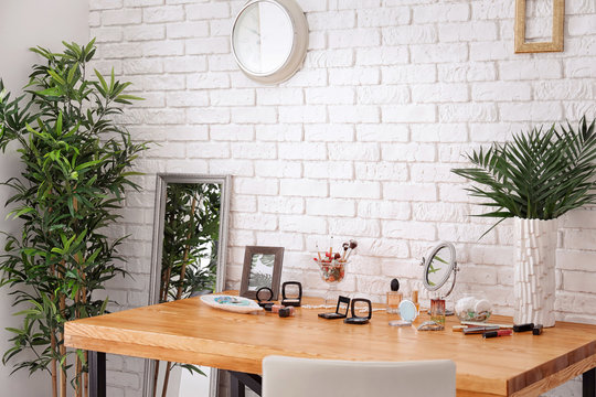 Set of decorative cosmetics and beauty accessories on dressing table indoors