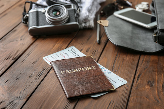 Passport and ticket on wooden table