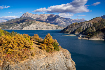 Serre Poncon Lake in Autumn with view on the Grand Morgon Peak. Hautes-Alpes, Southern French Alps, France