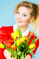 Obraz na płótnie Canvas Woman holding yellow and orange bouquet of tulips