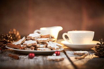 Cinnamon star cookies for christams with pine coins and little red christmas balls