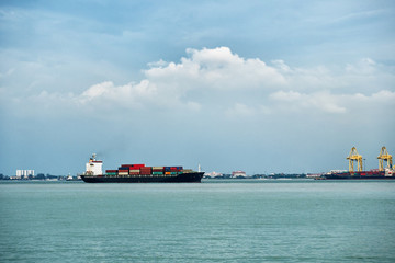 Fototapeta premium Cargo ship with containers near the port in Penang, Malaysia