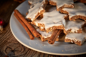 Cinnamon star cookies for christams with pine coins and little red christmas balls