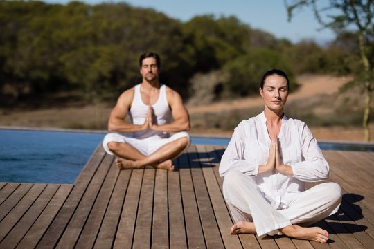 Couple performing yoga at safari vacation