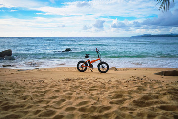 Deserted tropical beach and an electric bike. Thailand, Phuket