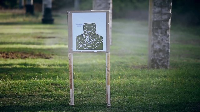 Outdoor target shooting with a 9mm pistol in a shooting range