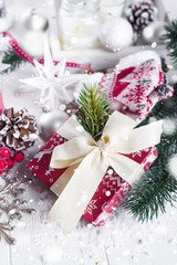 Fototapeta na wymiar Christmas fir tree, decor, gift box and mittens
