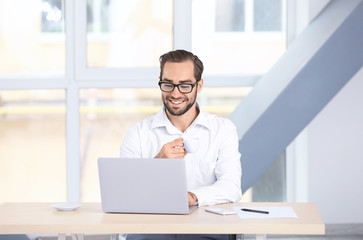 Attractive man with laptop at home