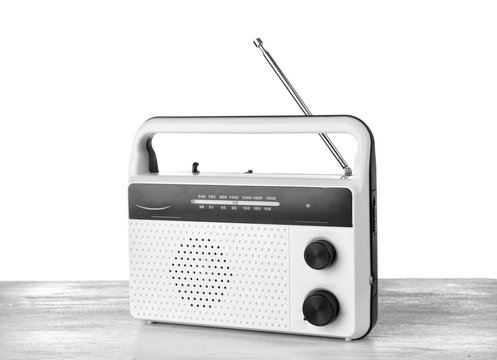 Retro radio on table against white background