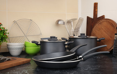 Different cooking utensils on table in kitchen