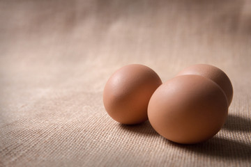 Fresh organic eggs on sackcloth(gunny) with copy space for text