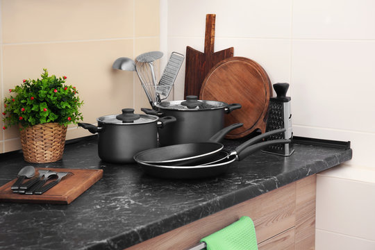 Different cooking utensils on table in kitchen