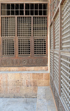 Wooden ornate windows over stone brick wall, Old Cairo, Egypt