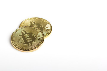 Two bitcoins on white background with copyspace