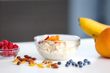 Tasty oatmeal in bowl on table