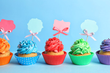 Tasty cupcakes on color background