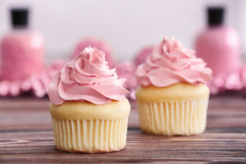 Delicious vanilla cupcakes on table