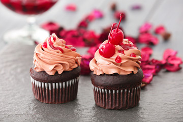 Delicious chocolate cupcakes on table