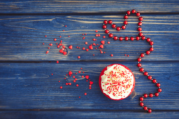 Composition with delicious red velvet cupcake on wooden background
