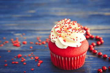 Delicious red velvet cupcake on table