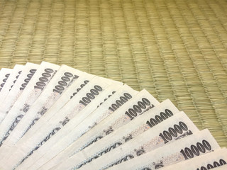 close up on japanese bank notes on tatami floor