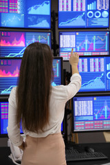 Female stock trader working in office