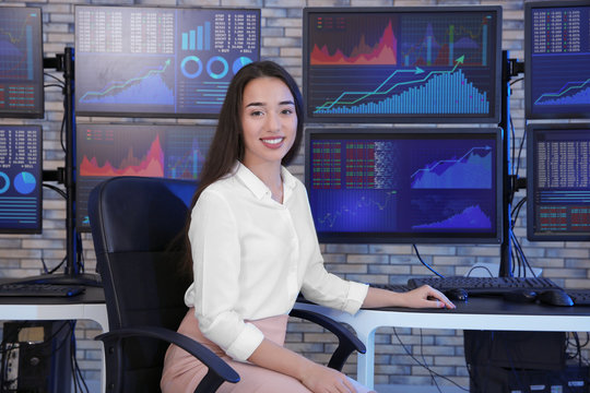 Female stock trader working in office