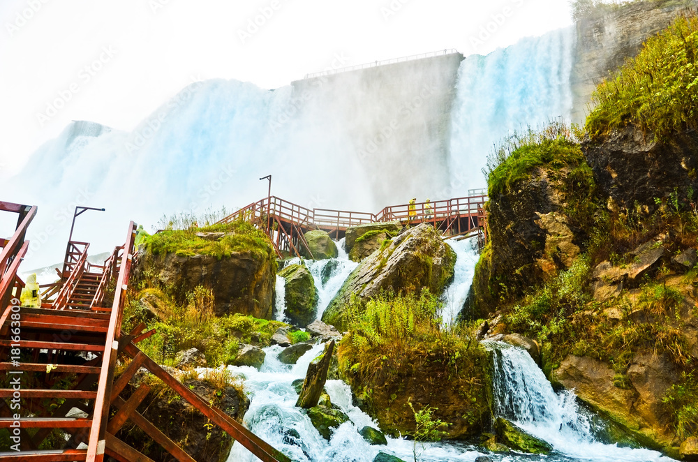 Wall mural view from the bottom of niagara falls at american side with water splashing in the air