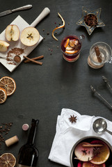Ingredients for Hot mulled wine with apple, orange, anise and cinnamon with fresh fruits on wooden table. Winter and fall. Christmas and holidays food.