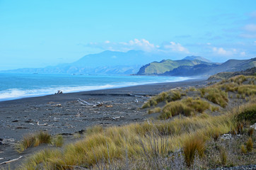 Black sand beach with mountains background from New Zealand's south island