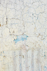 Surface of the wall with old damaged paint. Vertical background
