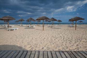 Rows of sun loungers and umbrellas on the beach.Tavira, Portugal