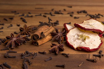 Dried orange slices on a wooden background arranged with cinnamon and anis